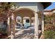 Beautiful backyard with stone pillars, outdoor living space, and a luxurious hammock by the pool at 11158 Warm Wind Way, Weeki Wachee, FL 34613