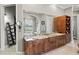 Bathroom showcasing a double sink vanity, hardwood cabinets, and a soaking tub at 11158 Warm Wind Way, Weeki Wachee, FL 34613