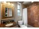 Bathroom features granite counters, vanity lighting, and a tiled shower with a white shower curtain at 11158 Warm Wind Way, Weeki Wachee, FL 34613