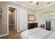 Cozy bedroom with a ceiling fan, wooden floor and furnishings at 11158 Warm Wind Way, Weeki Wachee, FL 34613