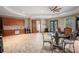 Spacious bonus room with kitchenette, tile floors, and a decorative dining table and chairs at 11158 Warm Wind Way, Weeki Wachee, FL 34613