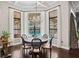 Bright dining area with a large window overlooking the pool and outdoor living area at 11158 Warm Wind Way, Weeki Wachee, FL 34613