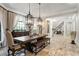 Dining area with travertine floors, pendant lights, and adjacent access to the staircase at 11158 Warm Wind Way, Weeki Wachee, FL 34613