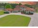Grand two-story Mediterranean home with a tile roof, arched windows, and lush landscaping at 11158 Warm Wind Way, Weeki Wachee, FL 34613