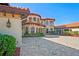 Elegant Mediterranean-style home with a terracotta roof, arched windows, and manicured landscaping at 11158 Warm Wind Way, Weeki Wachee, FL 34613