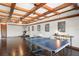 Large game room with wooden beam ceiling and ping pong table at 11158 Warm Wind Way, Weeki Wachee, FL 34613