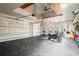 Spacious garage with multiple bays, black flooring, transom windows, and 2 motorcycles at 11158 Warm Wind Way, Weeki Wachee, FL 34613