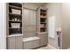 Laundry room with neutral cabinetry, quartz countertop, storage baskets, and a wall mounted vacuum unit at 11158 Warm Wind Way, Weeki Wachee, FL 34613