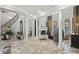 Bright living room features travertine floors, a fireplace, and elegant columns leading to the staircase at 11158 Warm Wind Way, Weeki Wachee, FL 34613
