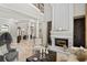 Elegant living room with fireplace, travertine floors, and stately columns at 11158 Warm Wind Way, Weeki Wachee, FL 34613