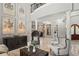 The living room boasts a high ceiling, travertine floors, and designer furnishings at 11158 Warm Wind Way, Weeki Wachee, FL 34613