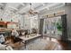 Inviting living room with stylish furniture, a coffered ceiling, and seamless access to the outdoor patio at 11158 Warm Wind Way, Weeki Wachee, FL 34613