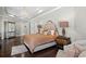 Elegant bedroom showcasing a chandelier, hardwood floors, and access to the ensuite at 11158 Warm Wind Way, Weeki Wachee, FL 34613
