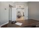 Open view from office to foyer with high ceilings and staircase at 11158 Warm Wind Way, Weeki Wachee, FL 34613