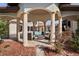 Relaxing outdoor space featuring a seating area with pillars overlooking a pool and lush landscaping at 11158 Warm Wind Way, Weeki Wachee, FL 34613