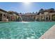 The in-ground pool has a rock waterfall, fountains, and adjacent covered lounge area at 11158 Warm Wind Way, Weeki Wachee, FL 34613