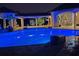 Luxurious outdoor pool area with ambient lighting, palm trees, and elegant poolside seating at 11158 Warm Wind Way, Weeki Wachee, FL 34613