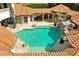 Aerial view of a backyard oasis featuring a sparkling pool, rock waterfall, and beautiful landscaping at 11158 Warm Wind Way, Weeki Wachee, FL 34613