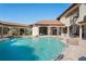 Beautiful backyard swimming pool with covered patio, stone accents, water features, spiral staircase and lounge chairs at 11158 Warm Wind Way, Weeki Wachee, FL 34613