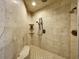 Large walk-in shower with tile surround, bench, and dual shower heads at 11158 Warm Wind Way, Weeki Wachee, FL 34613