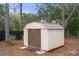 Exterior shot of backyard storage shed with brown doors and a small ramp at 12140 Folger St, Spring Hill, FL 34609