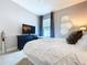 Bedroom featuring a ceiling fan, carpet flooring, large window, and modern furniture at 2385 Arboretum Dr, Palm Harbor, FL 34683