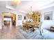 Formal dining room with tray ceilings, modern chandelier, and large hutch cabinet at 2385 Arboretum Dr, Palm Harbor, FL 34683