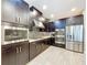 Modern kitchen featuring stainless steel appliances, dark cabinets, and stylish backsplash at 2385 Arboretum Dr, Palm Harbor, FL 34683