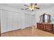 A bedroom with hardwood floors, a ceiling fan, and closet space at 2709 57Th S St, Gulfport, FL 33707