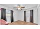 Bright bedroom featuring wood floors, ceiling fan, and windows with heavy curtains at 2709 57Th S St, Gulfport, FL 33707