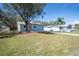 Charming single-story home with a well-manicured lawn and a quaint pink front door at 2709 57Th S St, Gulfport, FL 33707