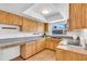 Functional kitchen featuring light wood cabinets and laminate countertops with under-cabinet lighting at 2709 57Th S St, Gulfport, FL 33707