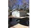 Exterior view of house and shed near pool, surrounded by lush trees and greenery for a tranquil setting at 3650 Bayshore Ne Blvd, St Petersburg, FL 33703