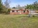 Charming single-story home featuring an attached garage, palm trees, and a well-maintained lawn at 3942 15Th Se Ave, Largo, FL 33771