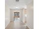 Hallway leading to a room featuring light wood paneling and a wall of windows at 3942 15Th Se Ave, Largo, FL 33771