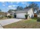 Charming home showcasing an attached two car garage, manicured lawn, and mature foliage at 4010 Levonshire Pl, Valrico, FL 33596