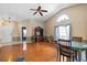 Open-concept living room with vaulted ceilings, hardwood floors, and a large window overlooking the front yard at 4010 Levonshire Pl, Valrico, FL 33596