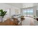Bright living room featuring modern decor, stylish furnishings, and sliding glass doors with a beautiful waterfront view at 4993 Bacopa S Ln # 304, St Petersburg, FL 33715