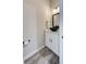 Stylish half bathroom features a floating vanity with bowl sink, sleek fixtures, and wood-look flooring at 817 Wilkie St, Dunedin, FL 34698