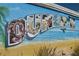 A colorful Dunedin mural featuring local food, drinks, and beach scenes at 817 Wilkie St, Dunedin, FL 34698