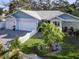 Well-maintained home featuring manicured landscaping, a white picket fence, and a charming entrance at 817 Wilkie St, Dunedin, FL 34698