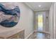 Elegant foyer with stylish flooring, decorative wall art, and a unique glass-paneled front door at 817 Wilkie St, Dunedin, FL 34698