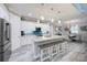 Beautiful open kitchen with a large center island, stainless steel appliances, and stylish pendant lighting at 817 Wilkie St, Dunedin, FL 34698
