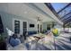 Outdoor lanai featuring dining and lounge seating, poolside access and screened enclosure at 817 Wilkie St, Dunedin, FL 34698
