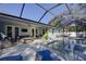 Outdoor lanai featuring dining and lounge seating, poolside access and screened enclosure at 817 Wilkie St, Dunedin, FL 34698