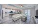 Open-concept living space with modern furnishings, an island kitchen, and great natural lighting at 817 Wilkie St, Dunedin, FL 34698