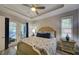 Bedroom featuring a bed with padded headboard, doors to the outside and shuttered windows at 817 Wilkie St, Dunedin, FL 34698