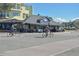 People on bicycles pass a charming waterfront restaurant with outdoor seating on a sunny day in Dunedin at 817 Wilkie St, Dunedin, FL 34698