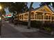 Exterior view of Sea Sea Riders Restaurant with string lights, white picket fence, and brick walkway at 817 Wilkie St, Dunedin, FL 34698
