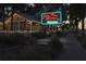 Exterior night view of Sea Sea Riders Restaurant with festive neon signage and outdoor seating at 817 Wilkie St, Dunedin, FL 34698